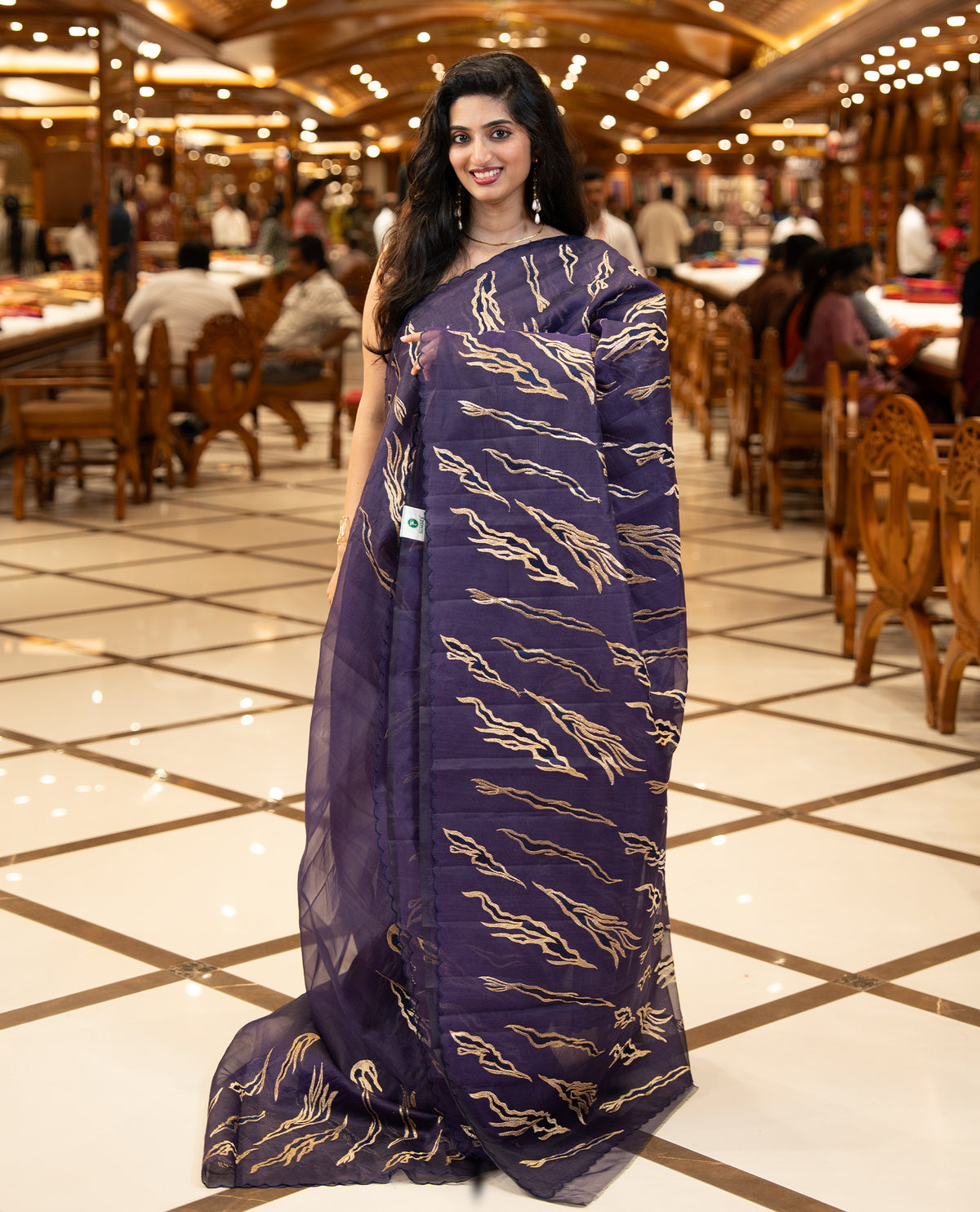 Violet colour sheer Organza saree featuring Gold thread embroidery with modern wavy & flame inspired motifs and scallop border, comes with matching organza blouse.