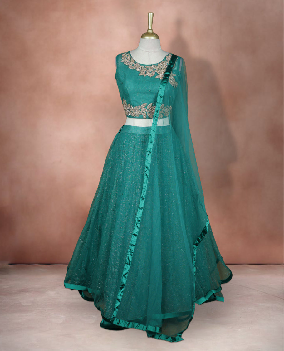 Teal green colour lehenga set with stitched sleeveless blouse featuring floral sequin embroidery on neckline and waist, paired with a matching shimmer layered flared lehenga and sheer dupatta