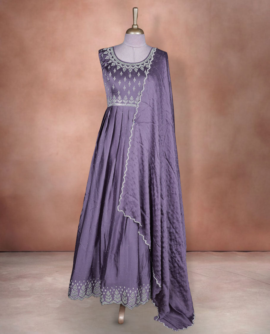 Dusty purple colour stitched gown set with sleeveless embroidered yoke, flared ankle‑length silhouette, and attached dupatta edged with scalloped beadwork and matching embroidered hem.