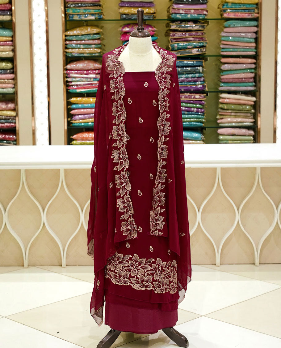 Maroon colour georgette salwar set featuring gold zari buttas on body, floral embroidery and scalp work on dupatta, paired with matching bottom.