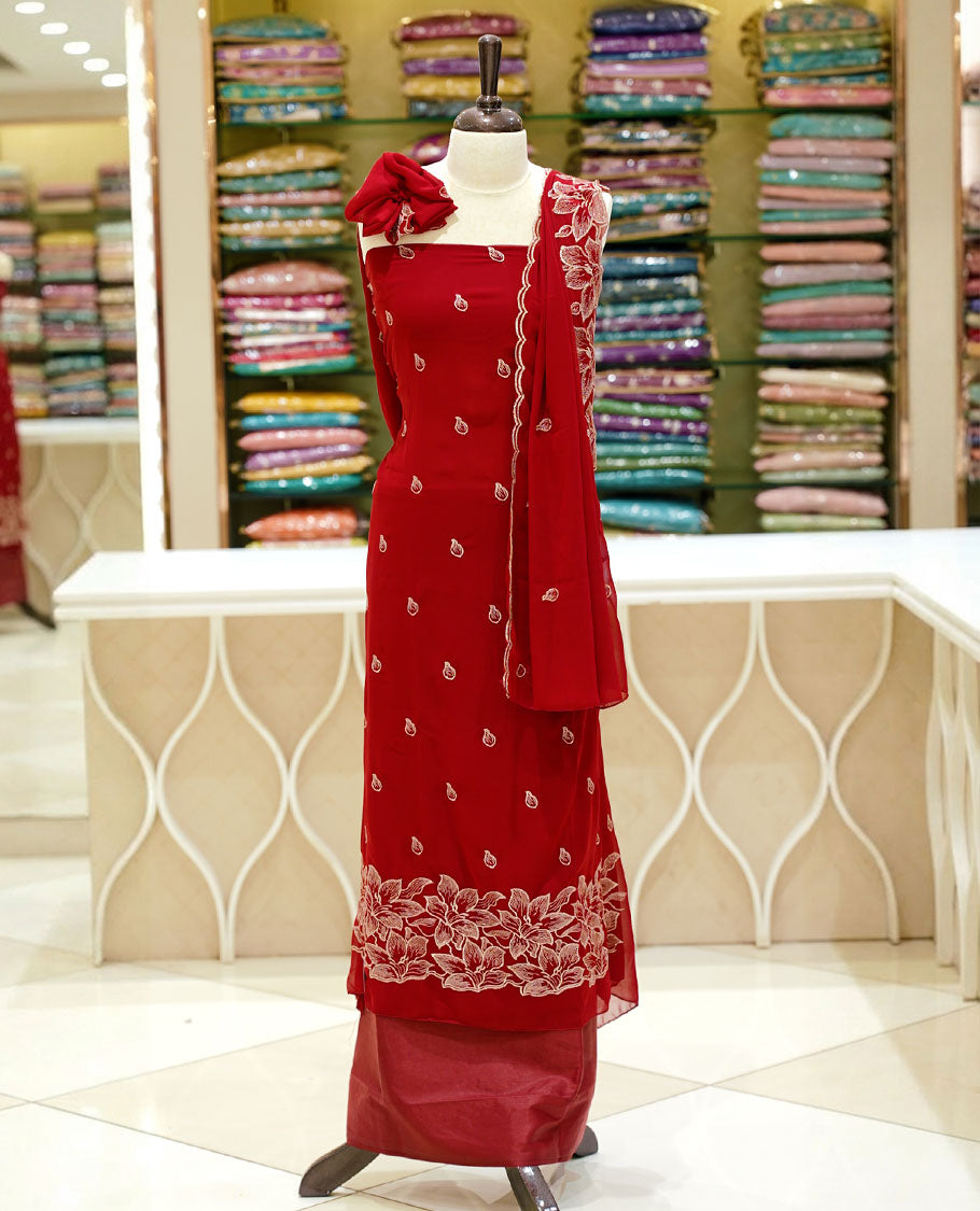 Red colour georgette salwar set featuring gold zari buttas on body, floral embroidery and scalp work on dupatta, paired with matching bottom.