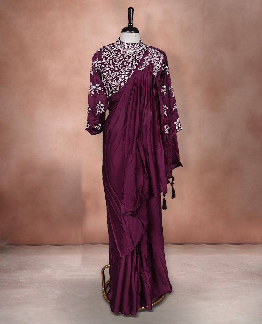 Wine colour ready to wear saree Fearturing intricate silver embroidery on the pallu, paired with a beats and thread embroidered matching blouse.