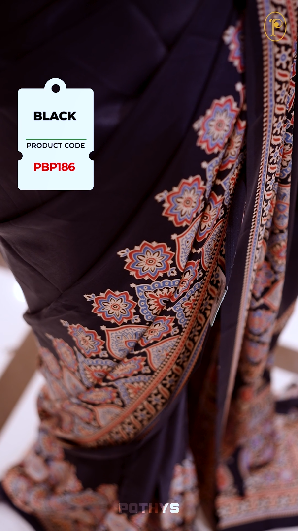 Black Semi modal silk saree featuring traditional Ajrakh print with intricate motifs and contrast borders, paired with a perfectly matching blouse & A timeless piece blending heritage with grace.