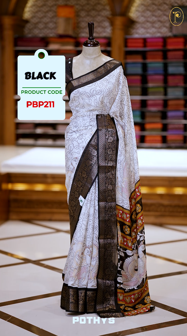 White colour Kalamkari saree featuring intricate prints, paired with a striking black and golden traditional border & The multicolor Kalamkari printed pallu adds vibrant charm, perfectly matched with a coordinating blouse.