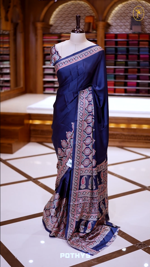 Blue Semi modal silk saree featuring traditional Ajrakh print with intricate motifs and contrast borders, paired with a perfectly matching blouse & A timeless piece blending heritage with grace.