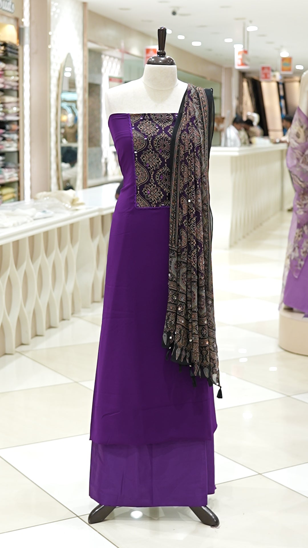 Lavender Georgette salwar material featuring Ajrakh print with mirror work on the yoke, paired with Ajrakh printed dupatta with mirror detailing and plain bottom.