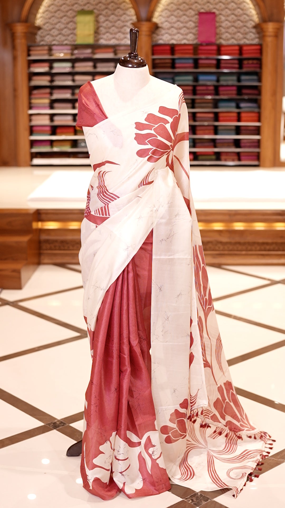 Pink colour semi khadi silk saree featuring bold white floral prints, The highlight is its ivory pallu adorned with elegant pink floral motifs and tassels & Comes with a matching blouse piece.