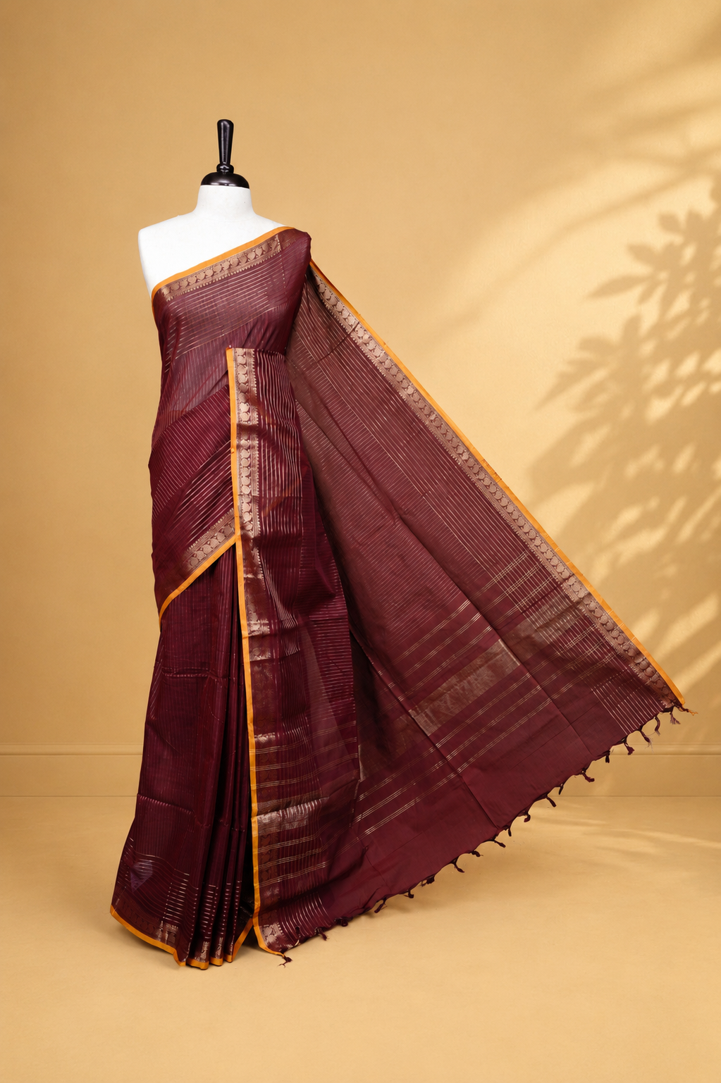 Maroon colour Chettinad cotton saree featuring Gold zari stripes on body, complemented by Self colour with Gold zari border mustard piping, paired with matching blouse piece.