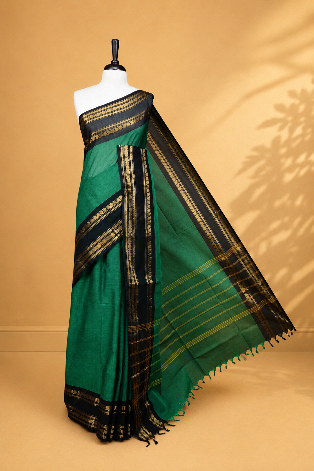 Green colour chettinad saree featuring Elegant Plain on body, complemented by contrast black colour with Gold zari border, paired wih matching blouse piece.