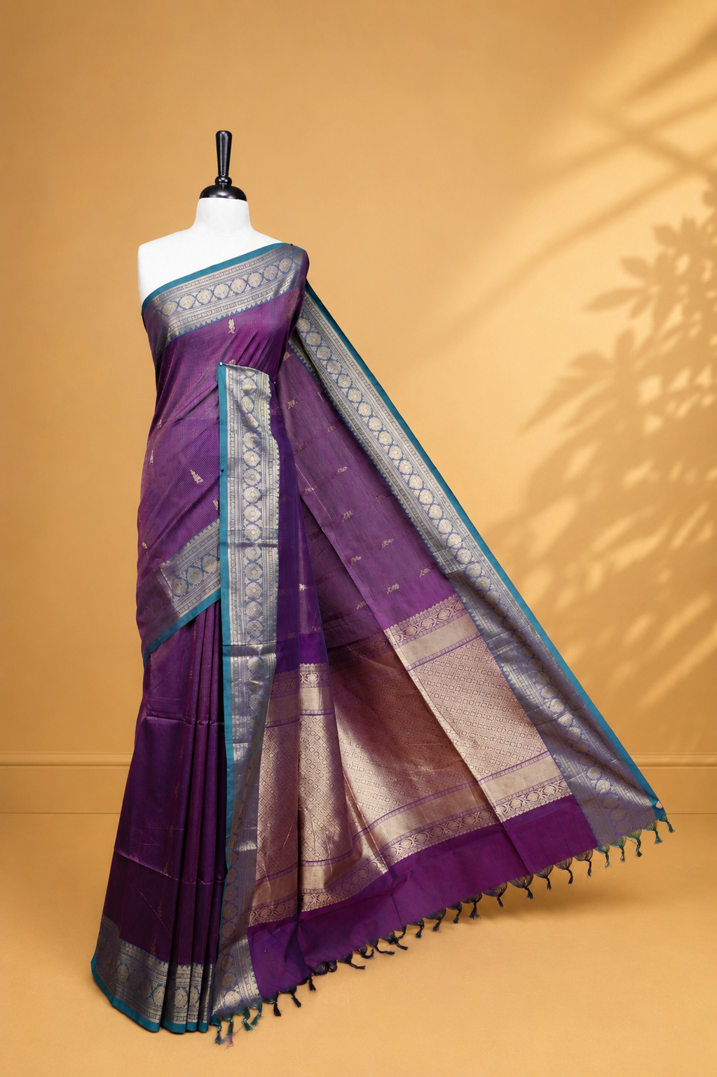 Purple colour chettinad cotton saree featuring gold zari stripes & motifs on body, complemented by Contrast Green colour with zari border, paired with matching blouse piece.