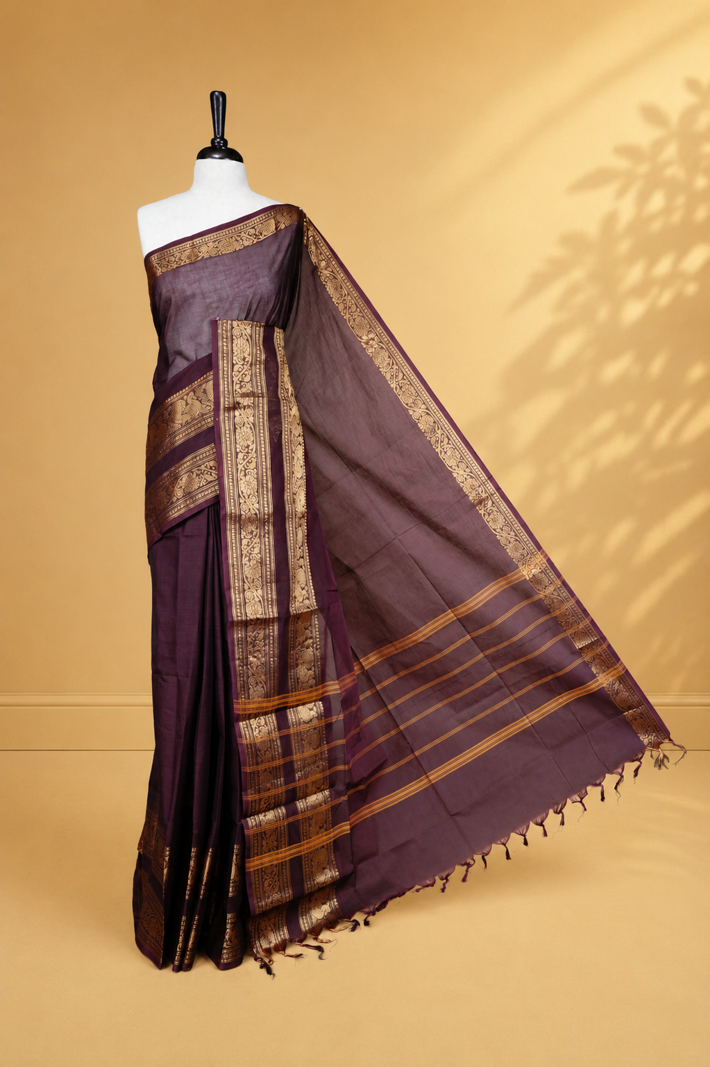 Chocolate brown colour Chettinad cotton saree featuring Elegant plain body, complemented by self colour with Gold zari border, paired with matching blouse piece.
