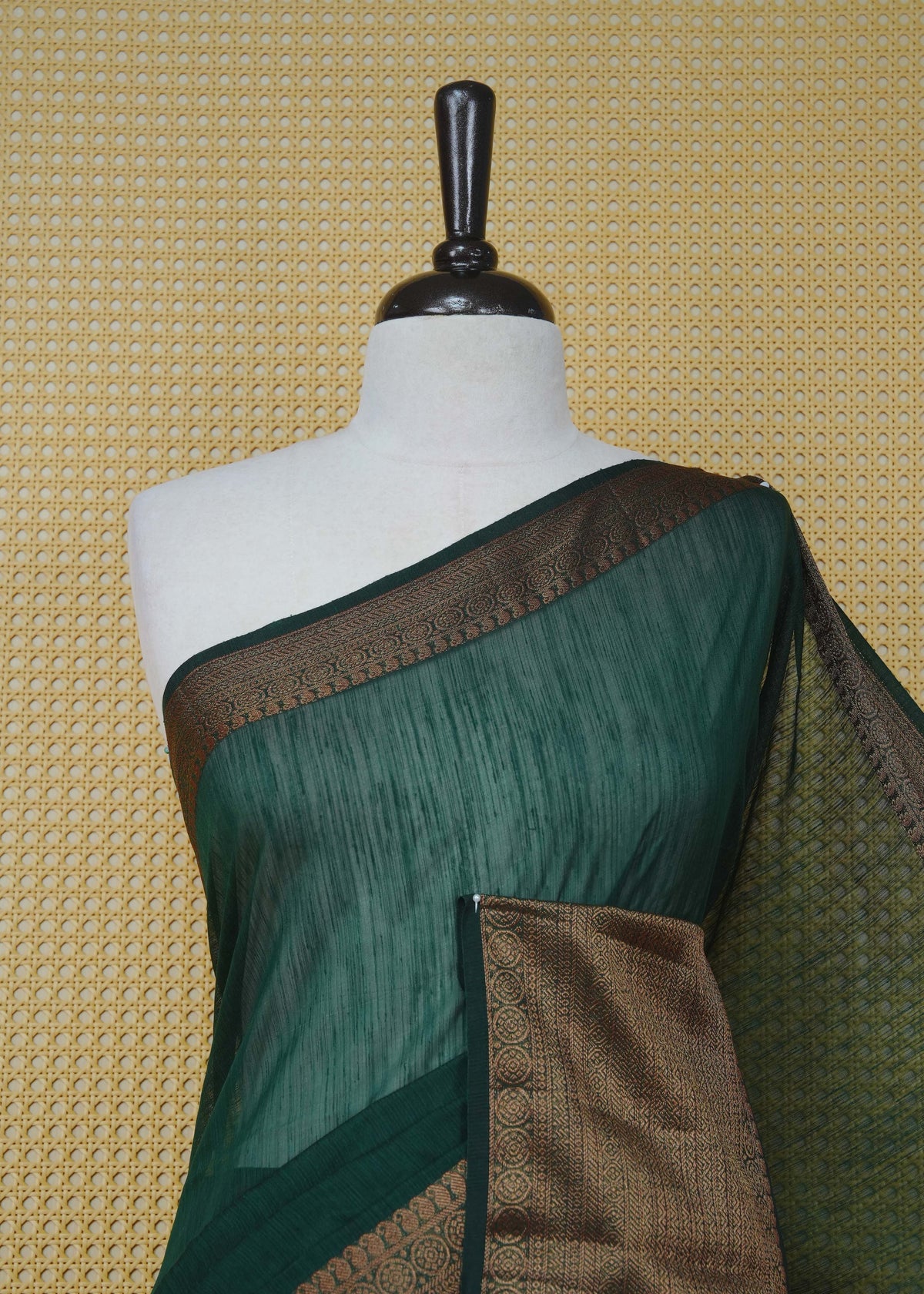 Dark green colour semi linen saree plain body, contrast self colour gold zari detailed border, grand pallu comes with matching blouse piece