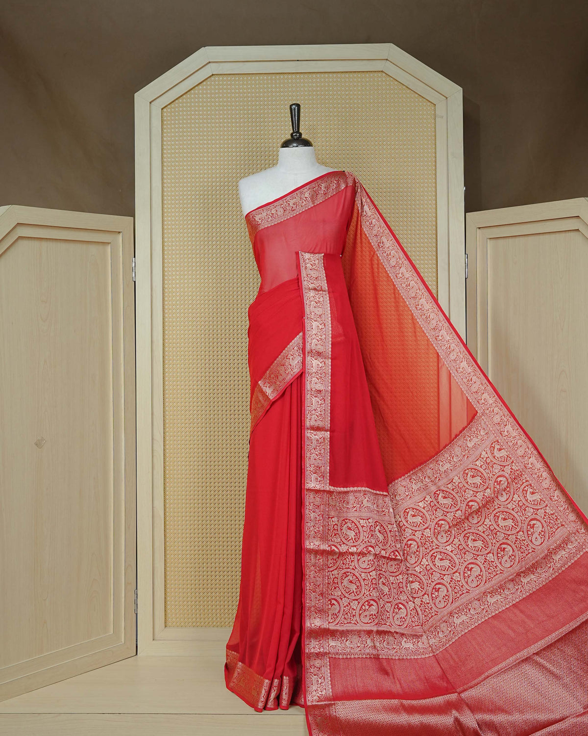 Vibrant red colour georgette saree having plain body, peacock & deer gold zari detailed border, comes with matching blouse piece