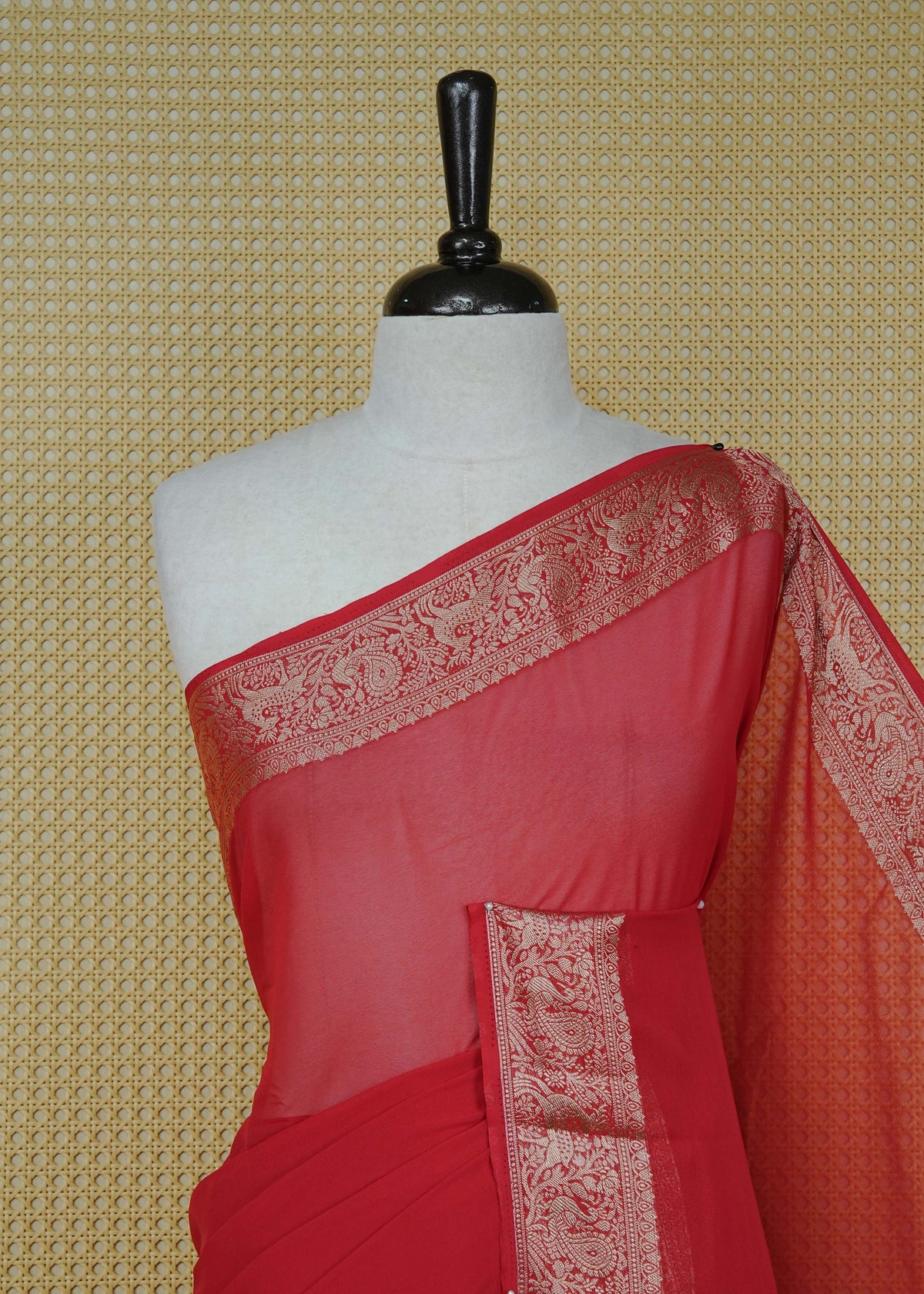 Vibrant red colour georgette saree having plain body, peacock & deer gold zari detailed border, comes with matching blouse piece