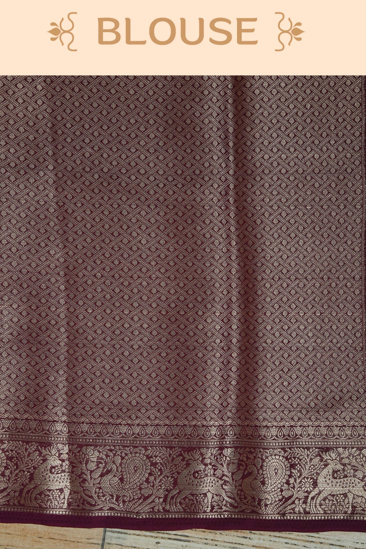 Wine colour georgette saree having plain body, peacock & deer gold zari detailed border, comes with matching blouse piece