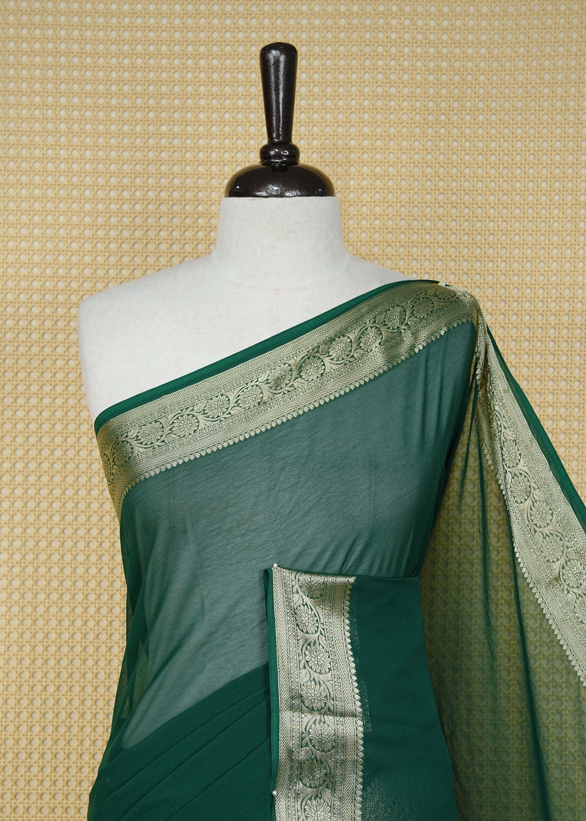 Bottle green colour georgette saree having plain boy, Floral Gold zari detailed pattern border, comes with matching blouse piece