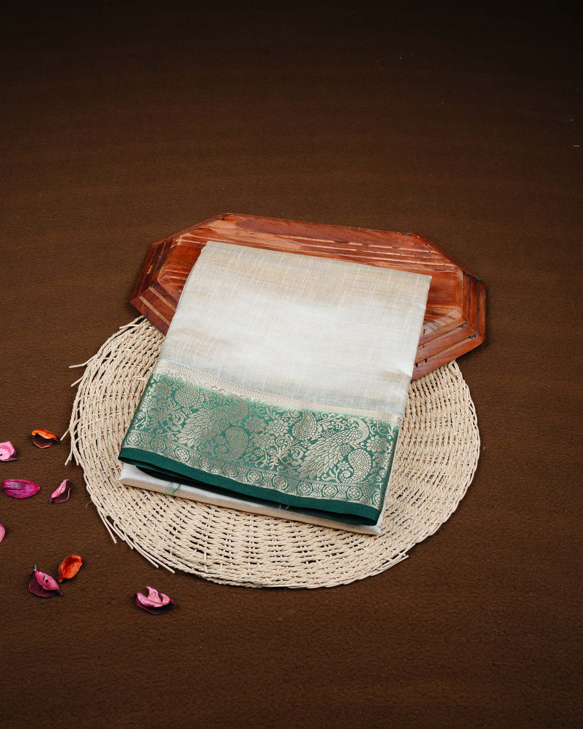 Cream colour Tussar silk saree Featuring Plain body, complemented by Contrast dark green colour gold zari peacock & mango motifs on border, paired with matching blouse piece.