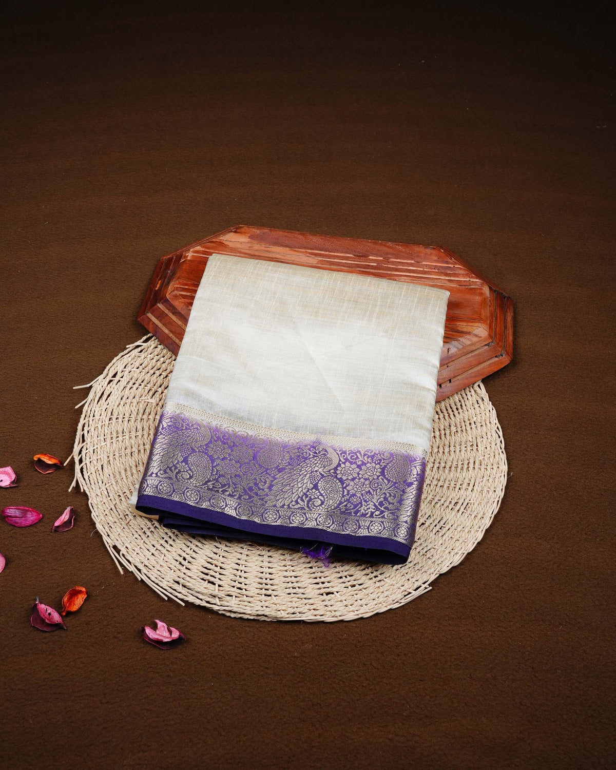 Cream colour Tussar silk saree Featuring Plain body, complemented by Contrast purple colour with gold zari peacock & mango motifs on border, paired with matching blouse piece.