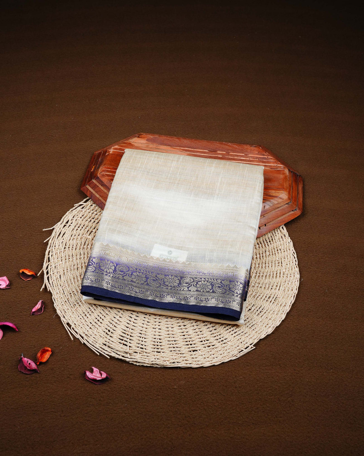 Cream colour Tussar silk saree Featuring Plain body, complemented by Contrast purple colour gold zari floral patterns on border, paired with matching blouse piece.