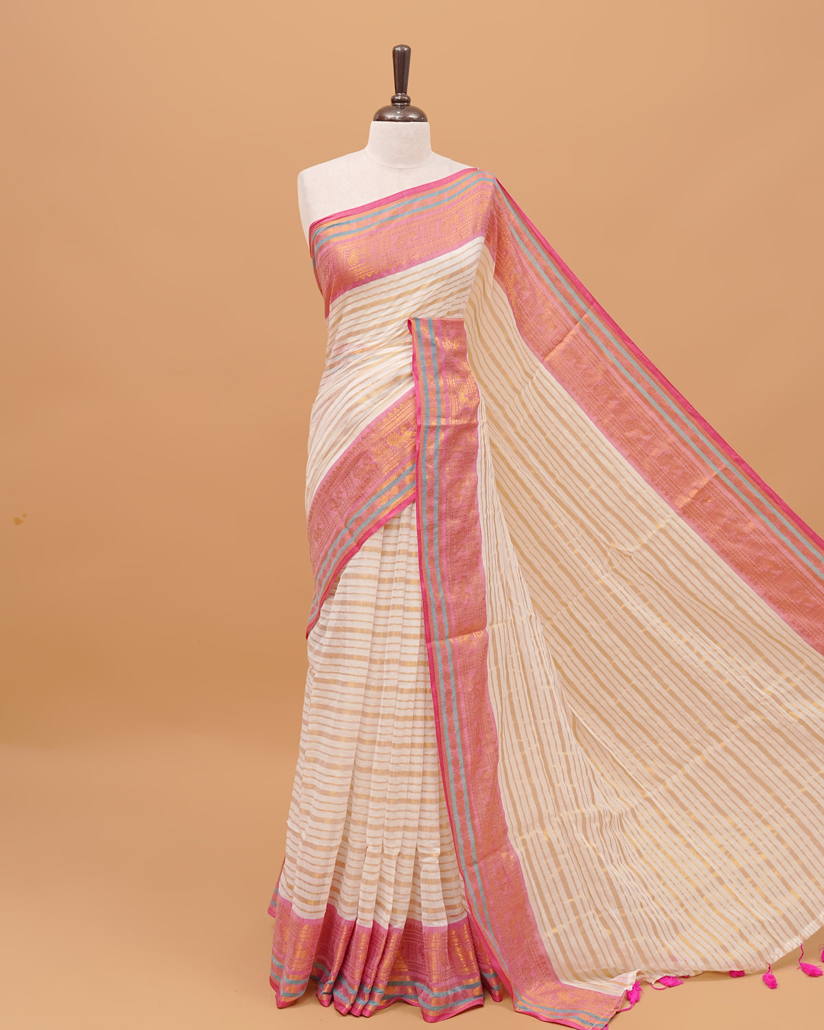 White Colour Mul Cotton Saree Featuring Plain body. With out Border Golden Strips on pallu comes With Tassels