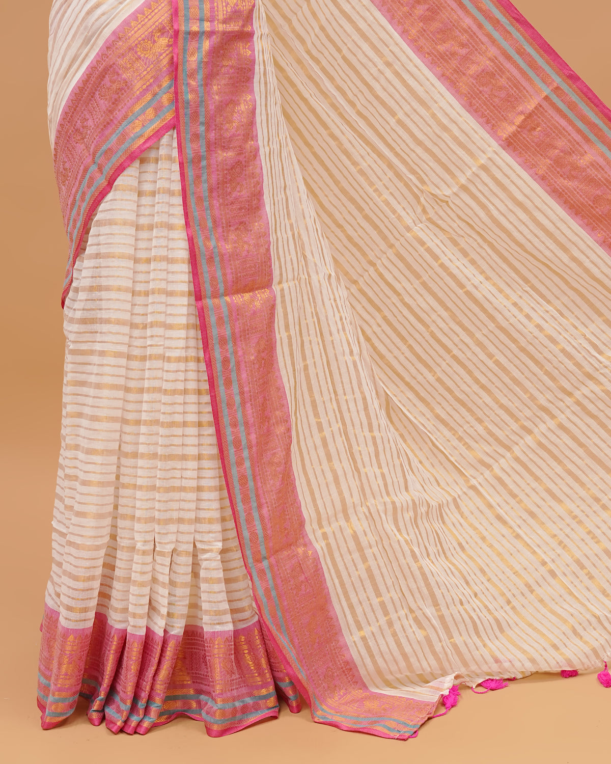 White Colour Mul Cotton Saree Featuring Plain body. With out Border Golden Strips on pallu comes With Tassels