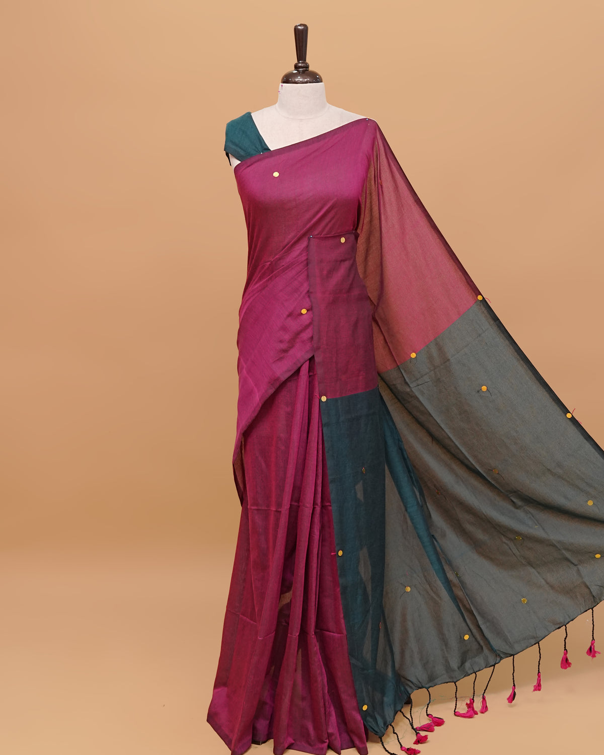 Peacock blue and wine coloured half and half mul cotton saree featuring elegant sequin detailing on the body, finished with a beautiful pallu adorned with tassels.