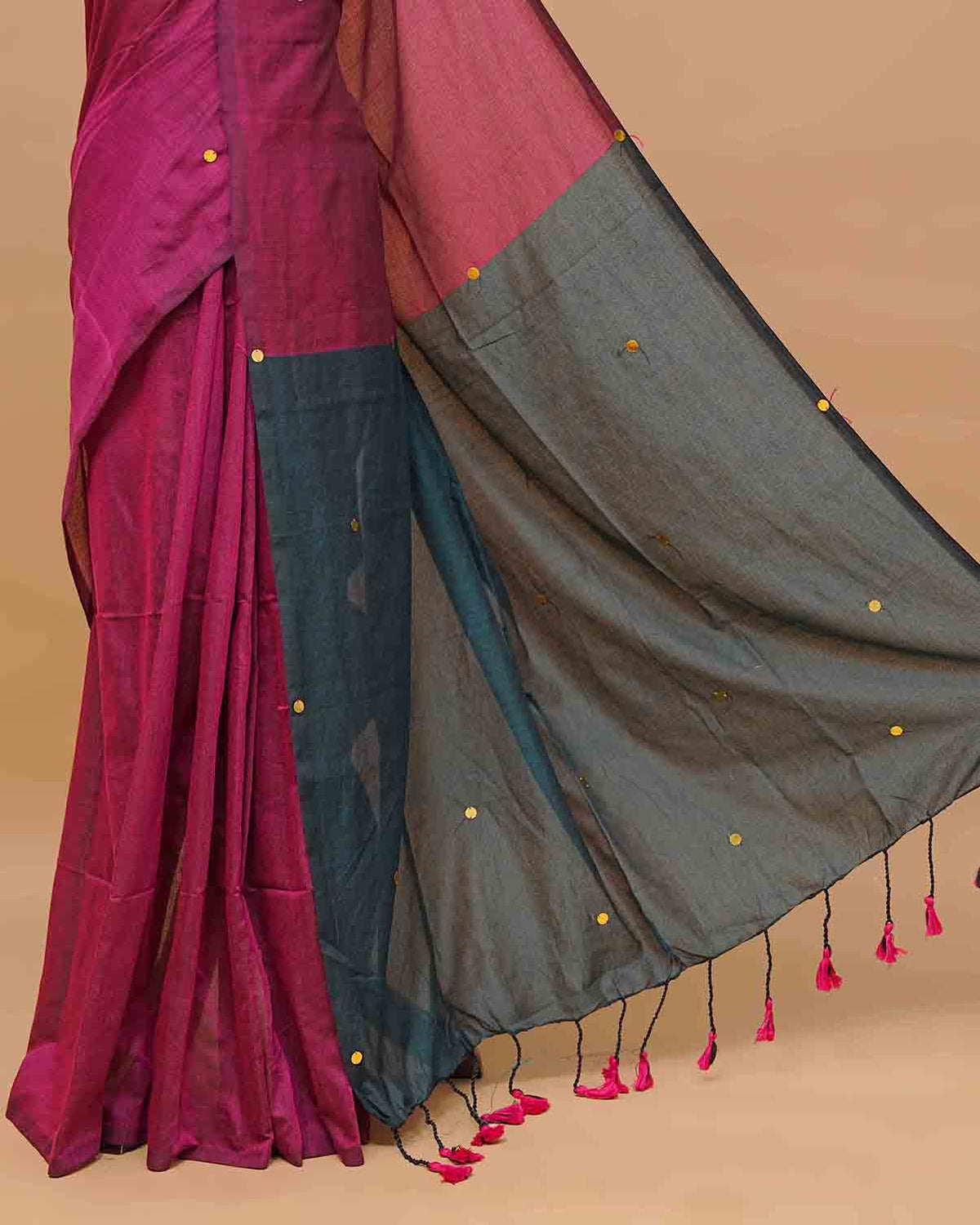 Peacock blue and wine coloured half and half mul cotton saree featuring elegant sequin detailing on the body, finished with a beautiful pallu adorned with tassels.