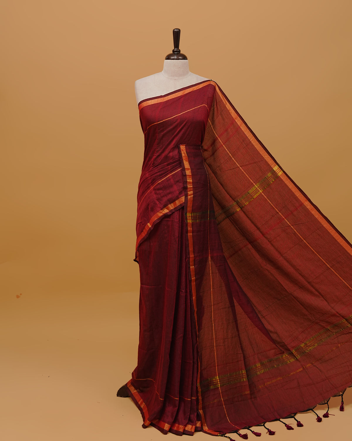 Maroon Colour Mul Cotton Saree Featuring Plain body. Gold zari Border & Golden Strips on pallu comes With Tassels