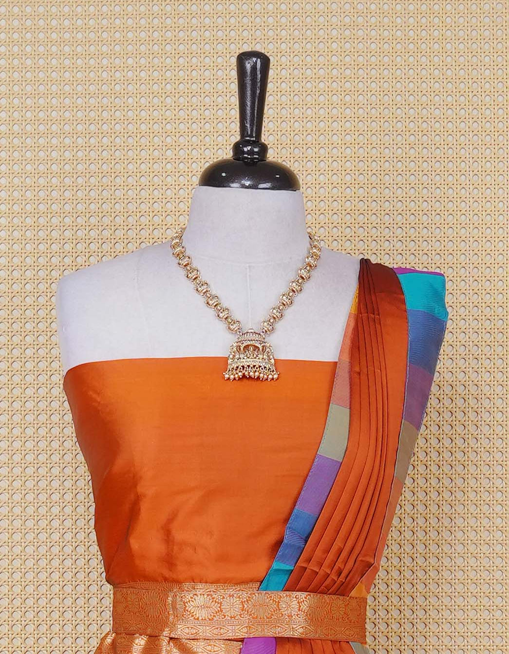 Rust Orange colour Semi Silk Semi stitched dhavani set featuring a Plain body with a matching Multi colour with gold zari bordered skirt & blouse piece and dupatta.
