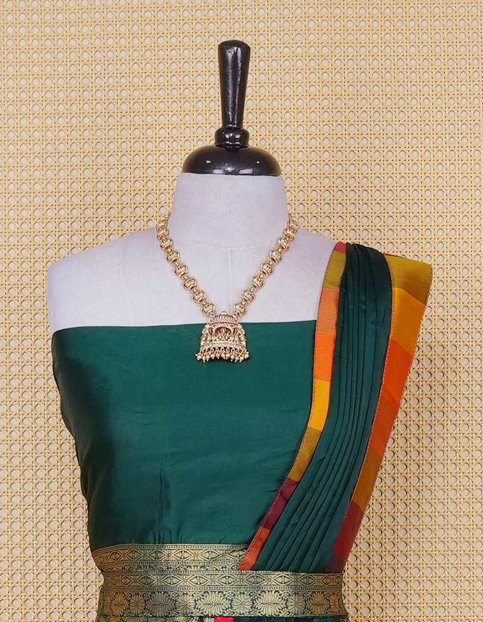 Bottle green colour Semi Silk Semi stitched dhavani set featuring a Plain body with a matching Multi colour with gold zari bordered skirt & blouse piece and dupatta.