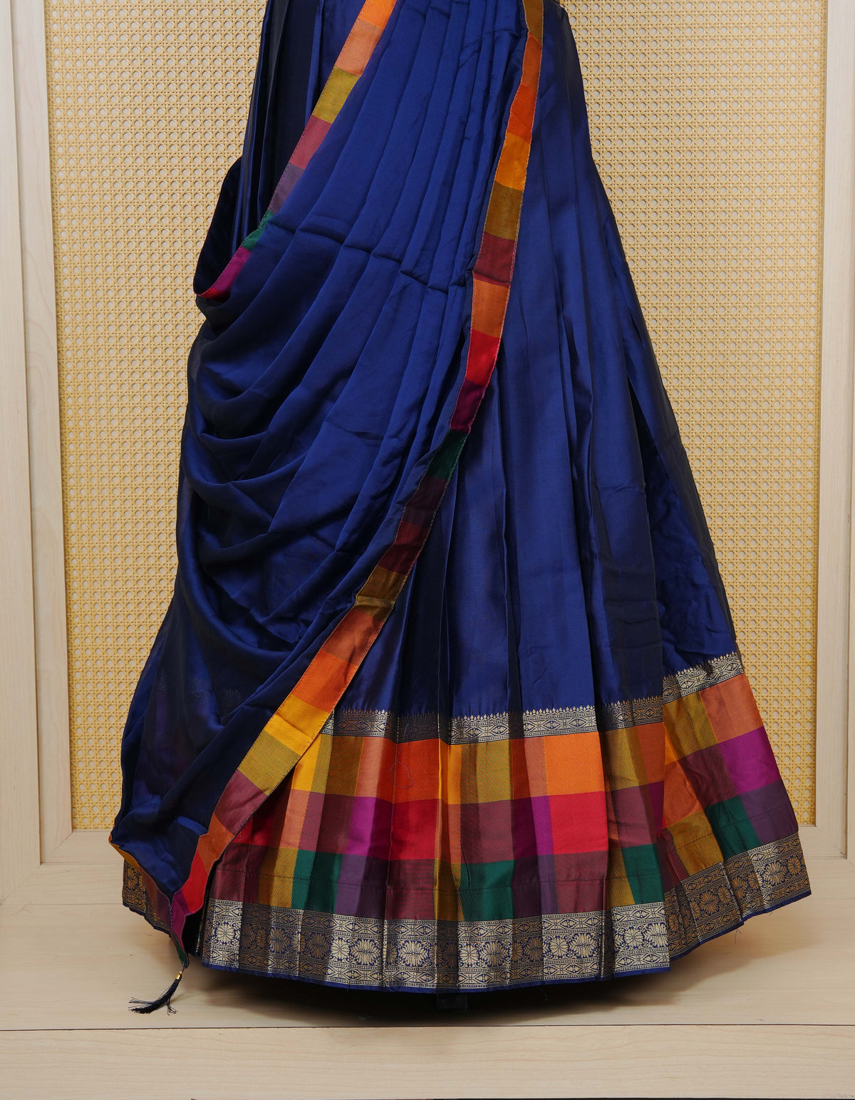 Navy blue colour Semi Silk Semi stitched dhavani set featuring a Plain body with a matching Multi colour with gold zari bordered skirt & blouse piece and dupatta.