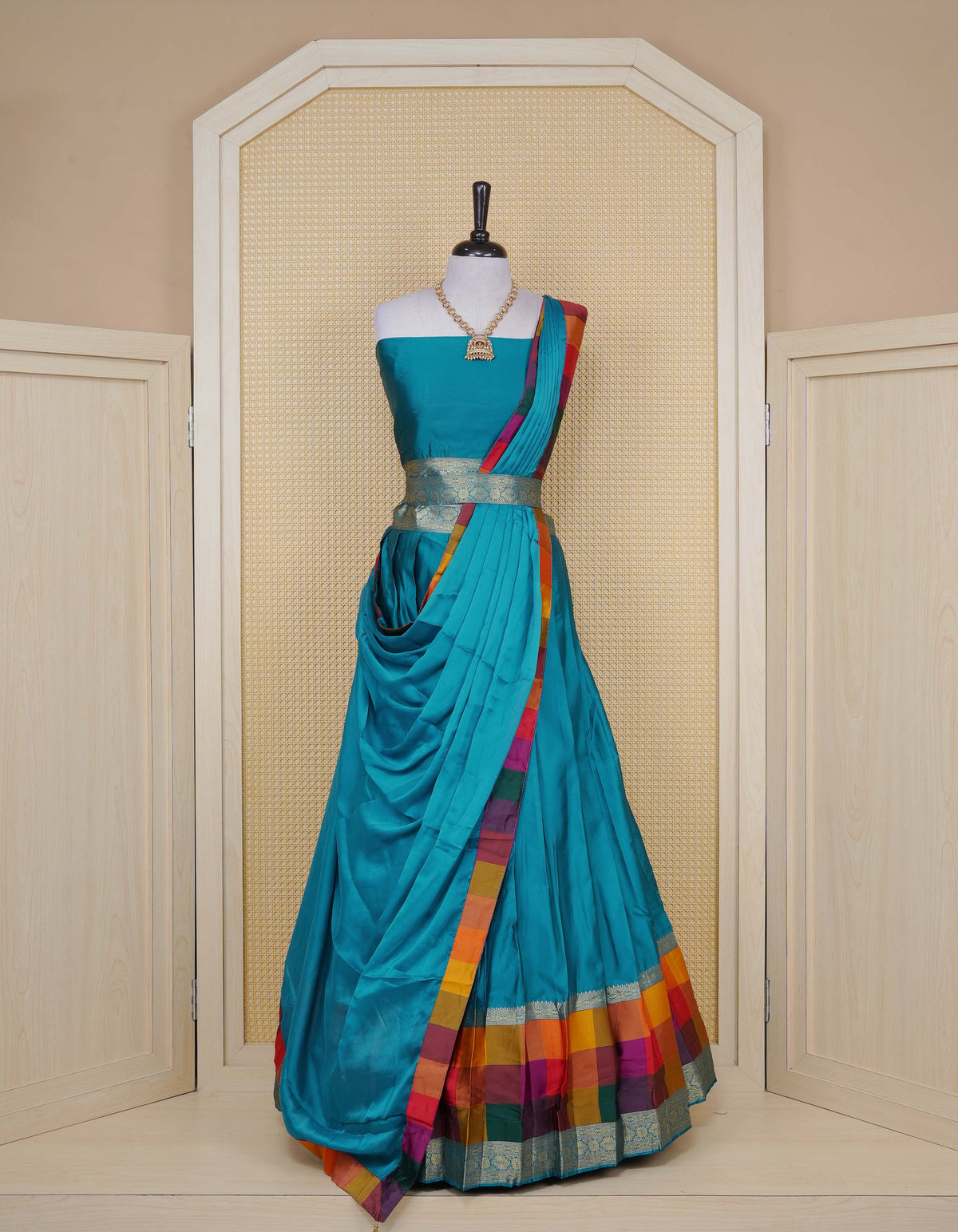 Peacock Green colour Semi Silk Semi stitched dhavani set featuring a Plain body with a matching Multi colour with gold zari bordered skirt & blouse piece and dupatta.