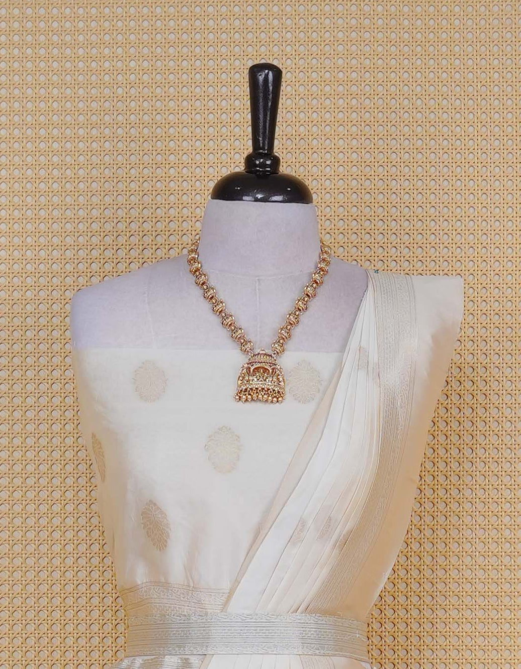 Cream colour Semi Silk Semi stitched dhavani set featuring Gold zari motifs on body ,contrast self colour with gold zari bordered skirt, paired with matching blouse piece & dupatta.