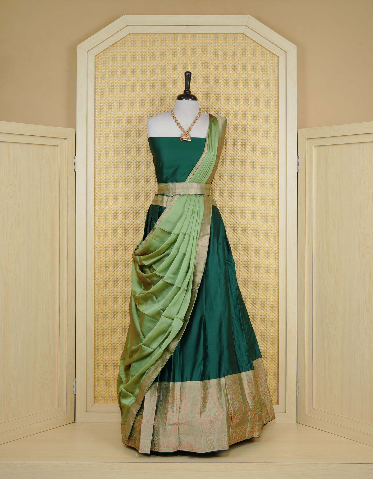 Bottle green colour Semi Silk Semi stitched dhavani set featuring a Plain body with a matching contrast Pista Green colour with copper zari bordered skirt & blouse piece and dupatta.
