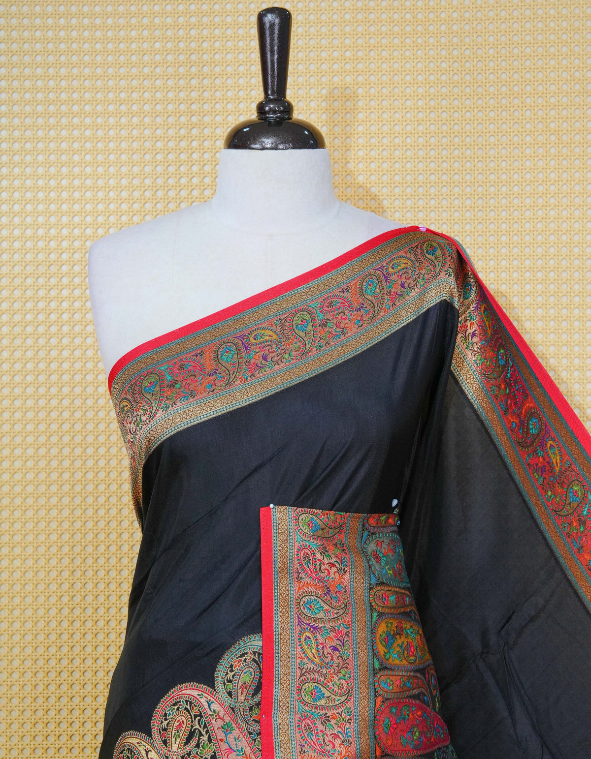 Black Colour Pashmina Saree featuring plain body, complemented by Contrast red colour with mango motifs zari patterns on border and Pallu, comes with matching blouse piece
