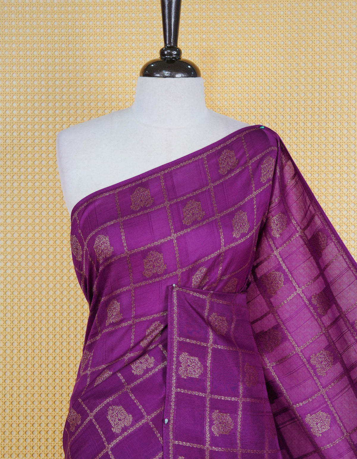 Purple colour semi banaras tussar georgette saree featuring gold zari check with motifs on body, no specific border and paired with matching blouse piece.