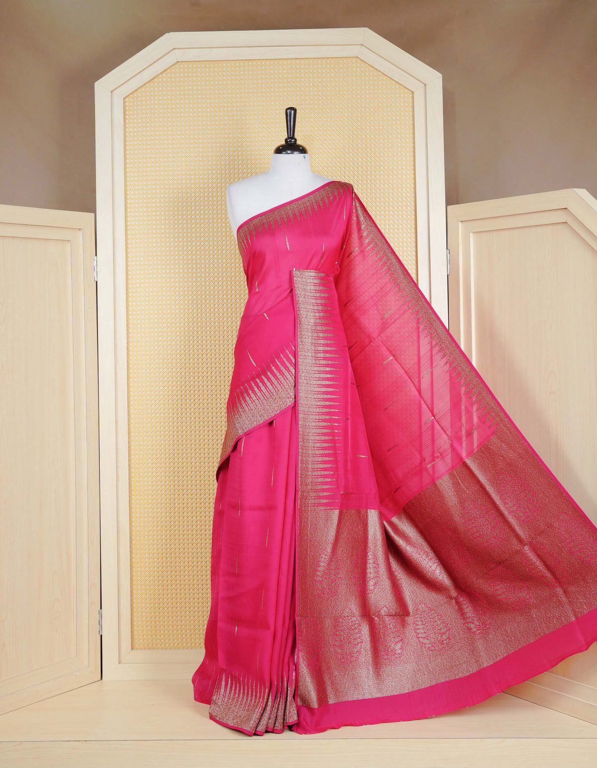 Pink colour semi banaras tussar georgette saree featuring gold zari pattern on body, finished with gold zari temple border and paired with matching blouse piece.