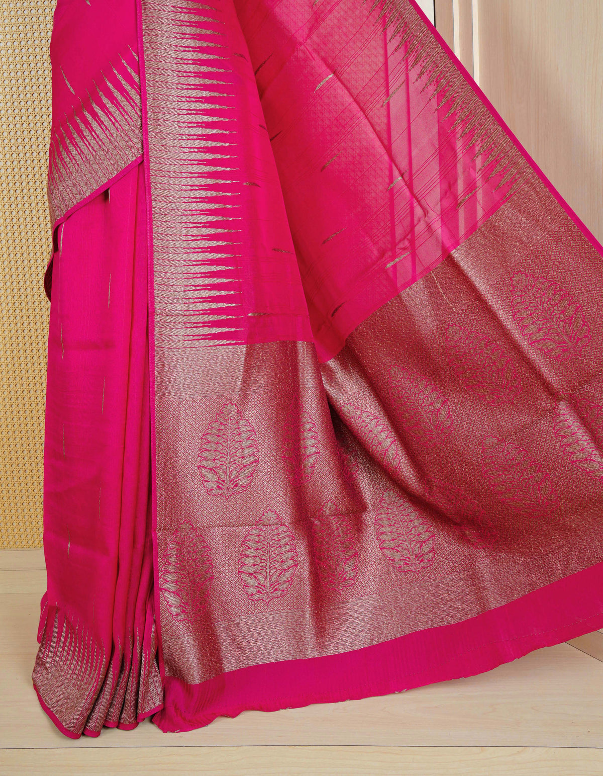 Pink colour semi banaras tussar georgette saree featuring gold zari pattern on body, finished with gold zari temple border and paired with matching blouse piece.