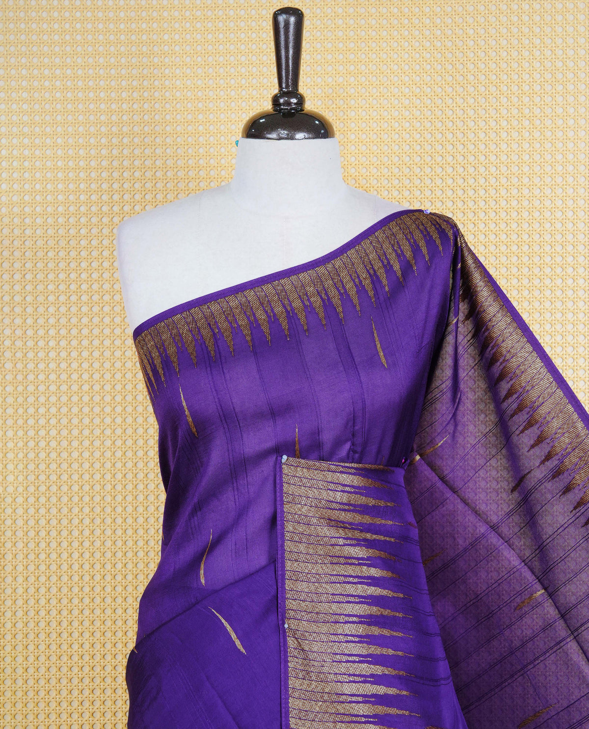 Rich purple colour semi banaras tussar georgette saree featuring gold zari pattern on body, finished with gold zari temple border and paired with matching blouse piece.