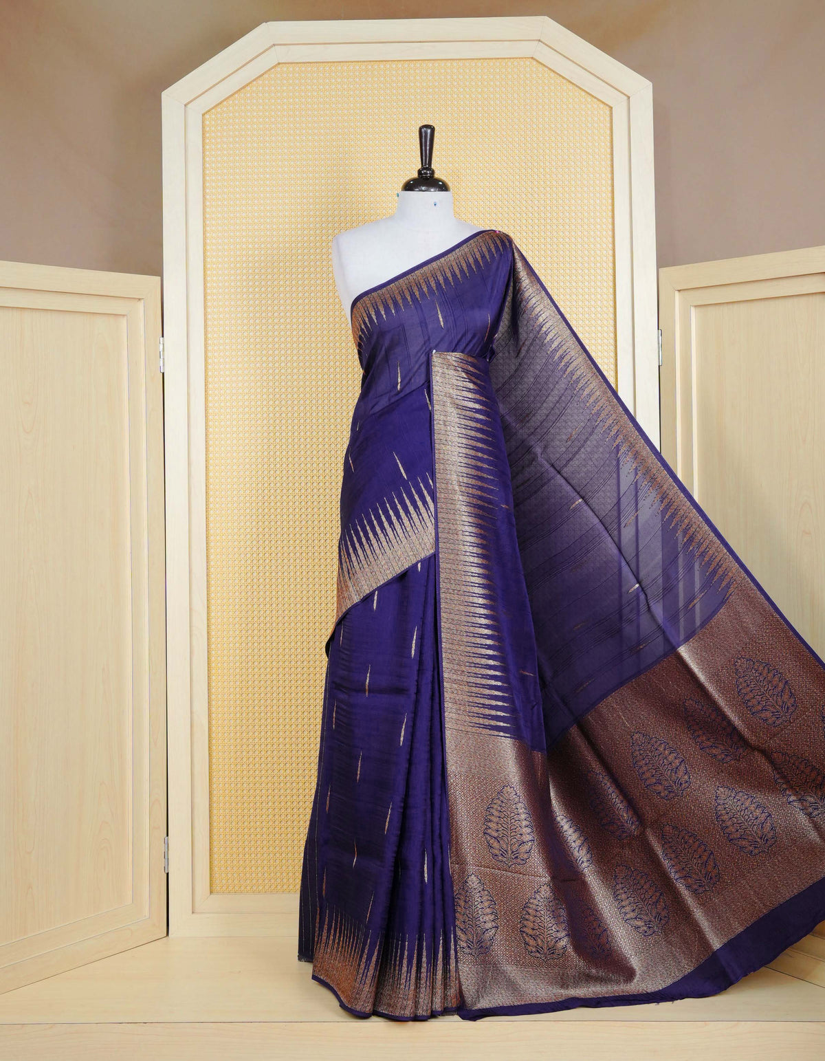 Dark blue colour semi banaras tussar georgette saree featuring gold zari pattern on body, finished with gold zari temple border and paired with matching blouse piece.