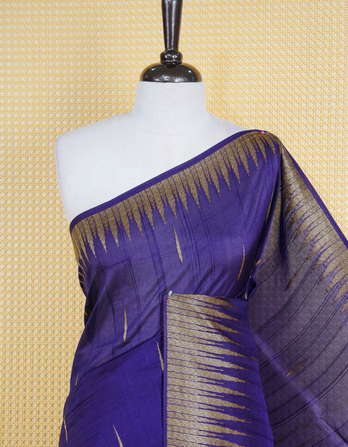 Dark blue colour semi banaras tussar georgette saree featuring gold zari pattern on body, finished with gold zari temple border and paired with matching blouse piece.