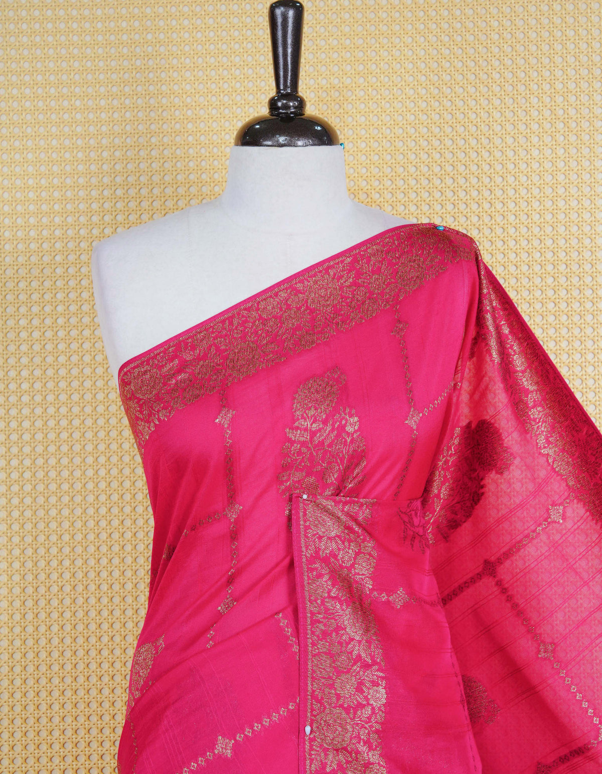 Pink colour semi banaras tussar georgette saree featuring gold zari floral pattern on body, finished with gold zari floral motifs on border and paired with matching blouse piece.