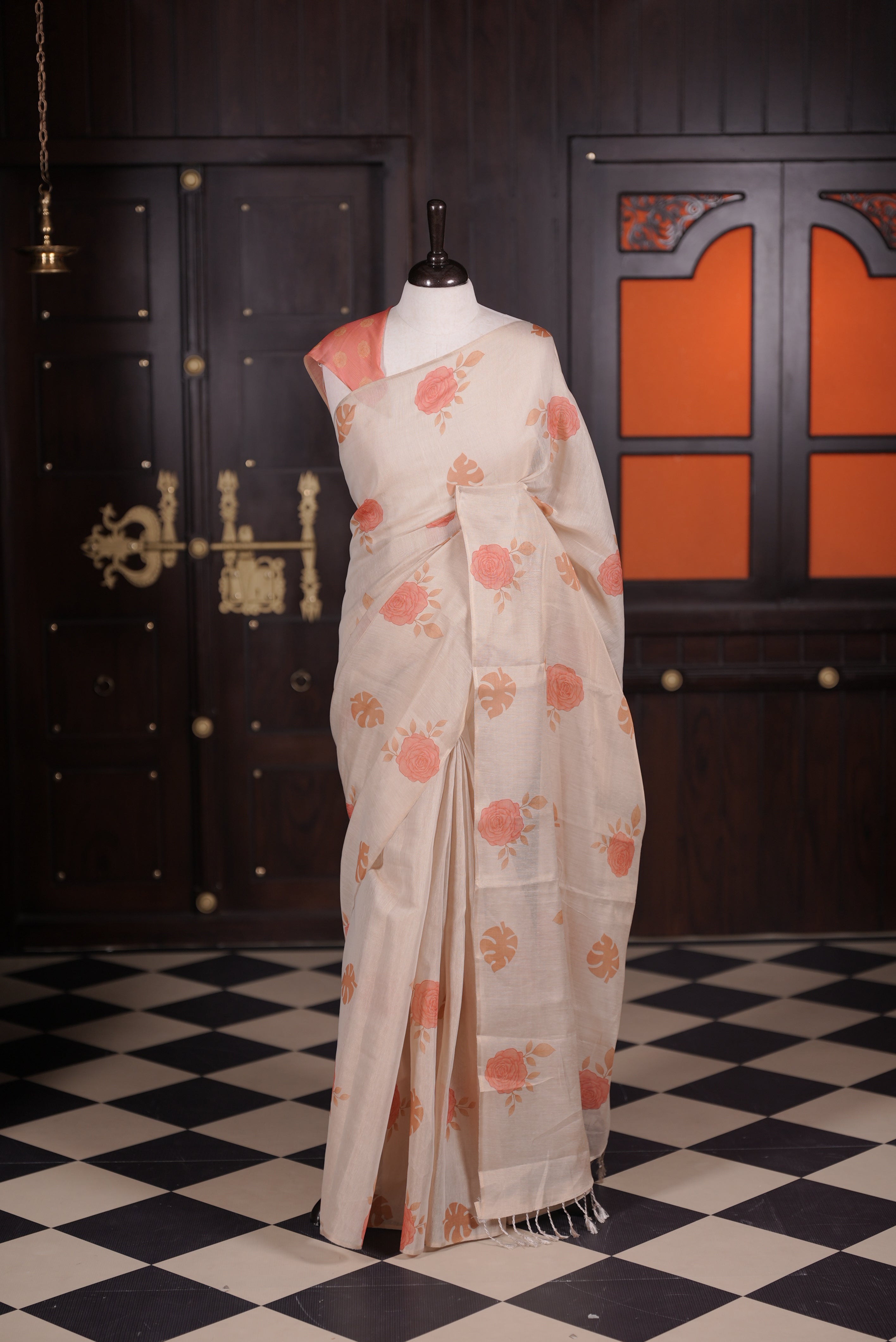 Beige colour semi linen tissue saree featuring Rose floral digital print throughout body, running pallu with tassel and paired with matching blouse piece.