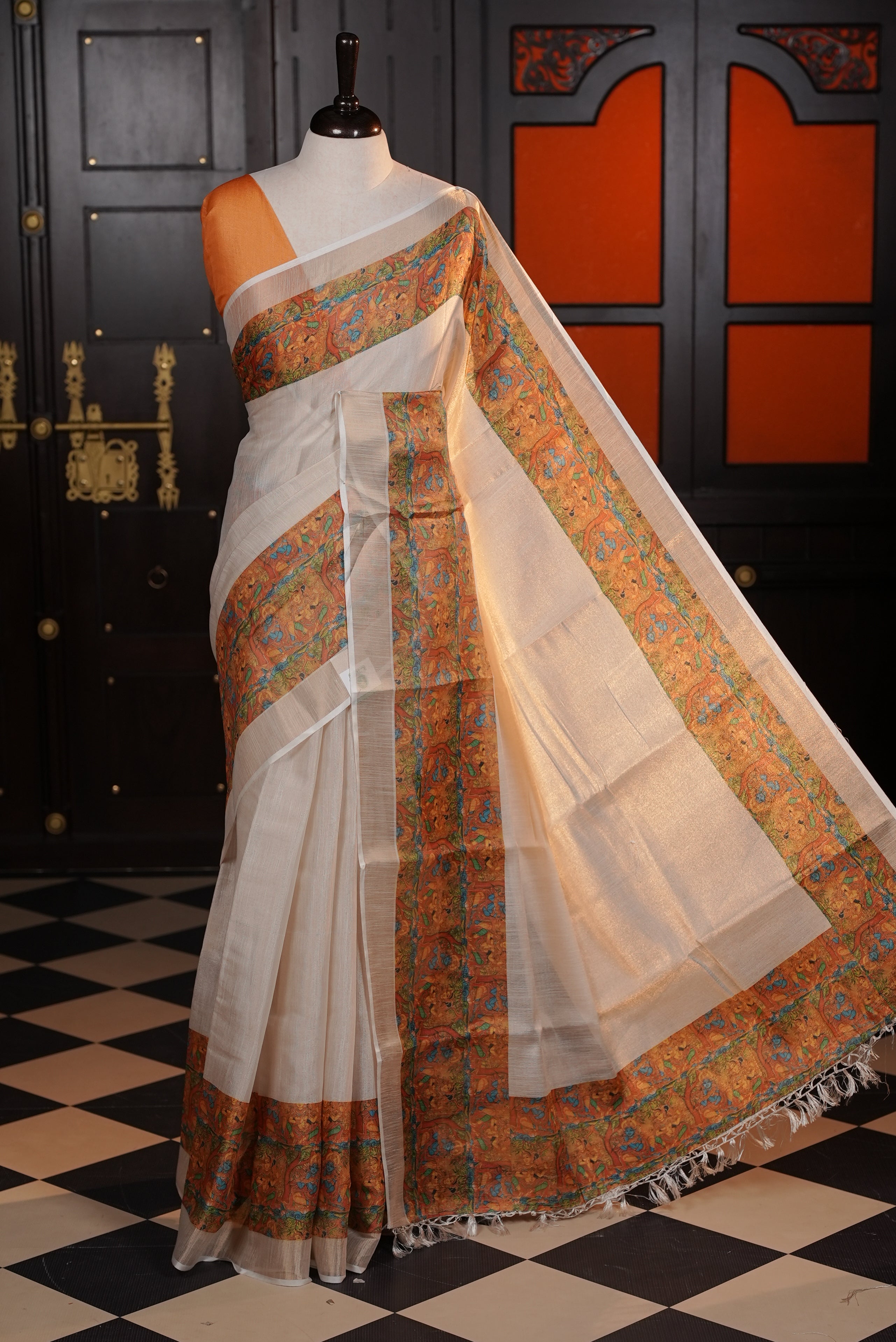 Light gold colour semi tissue silk saree with a yellow printed border, paired with a contrast blouse piece.