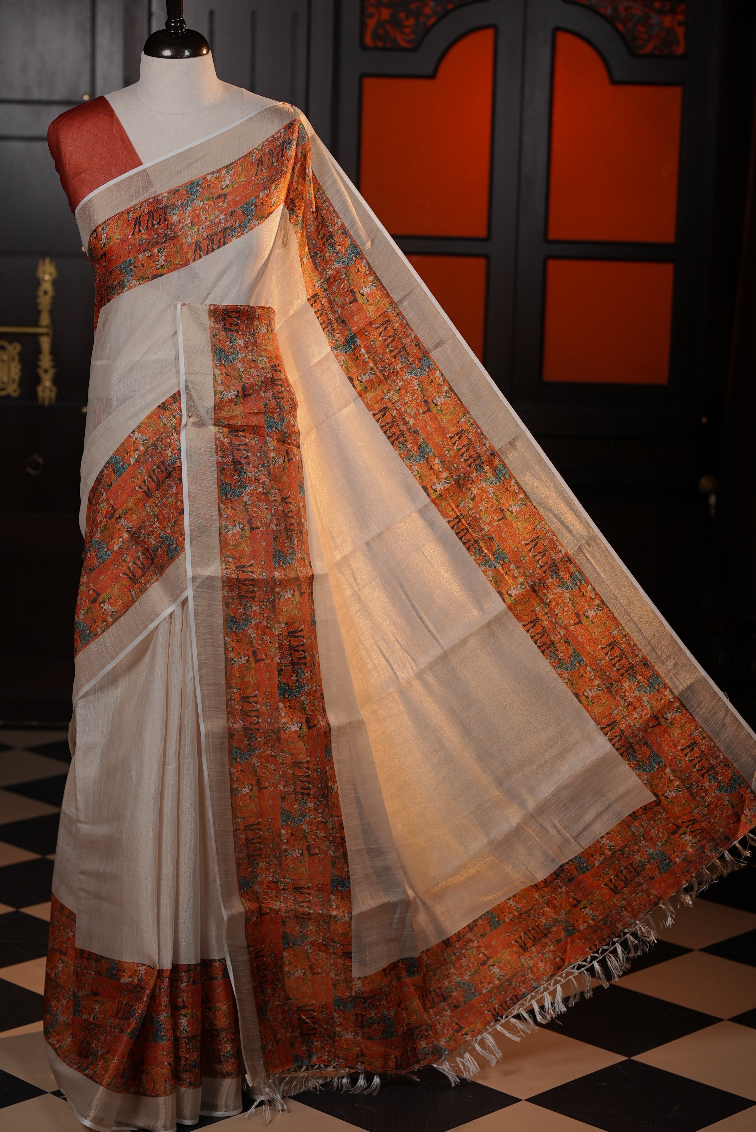 Light gold colour semi tissue silk saree with a Brick colour printed border, paired with a contrast blouse piece.