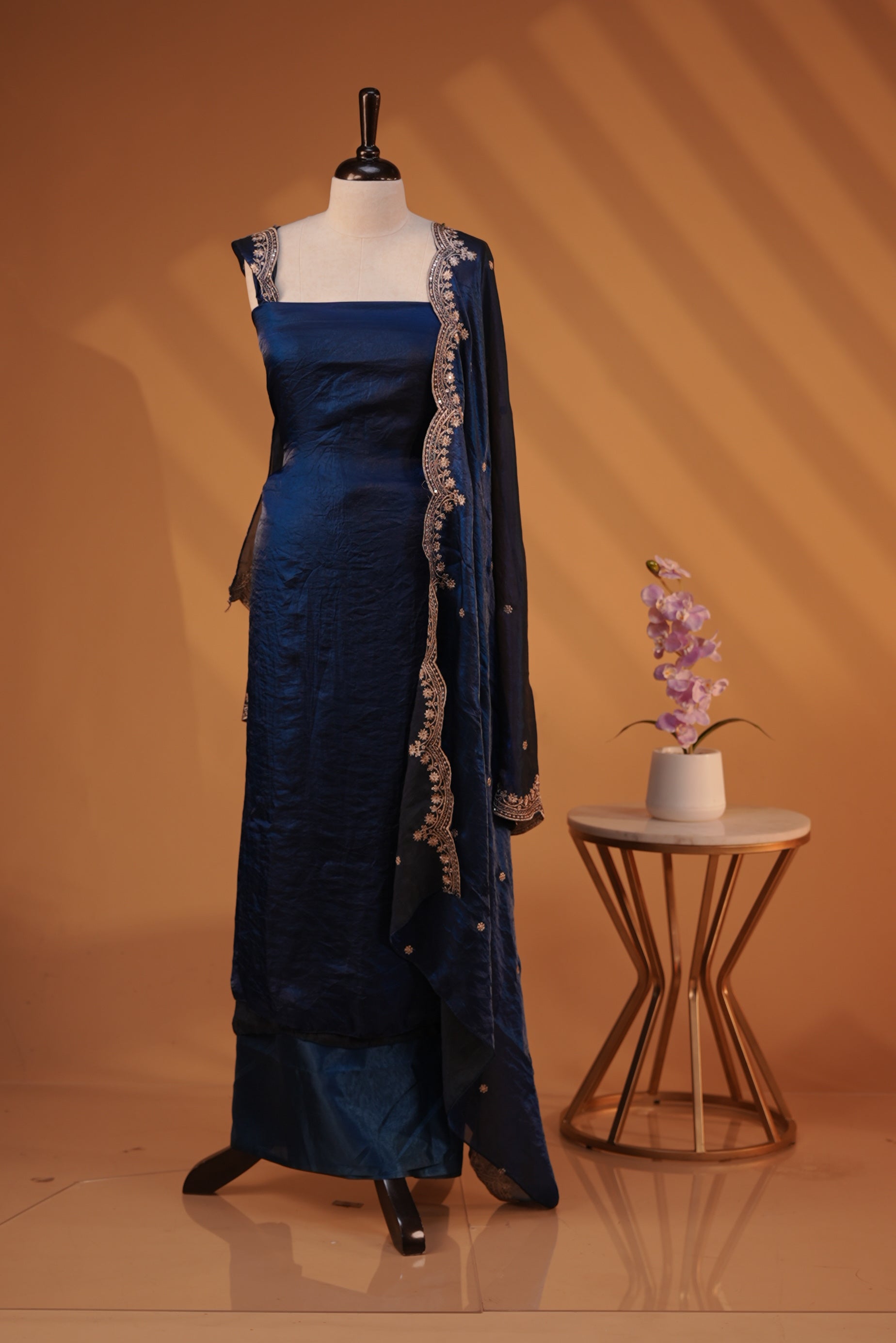 Dark Blue colour Fendy silk salwar material With Elegant plain body with lining, Comes with santoon bottom, Fendy silk dupatta With Floral buttas & Scalp Border.