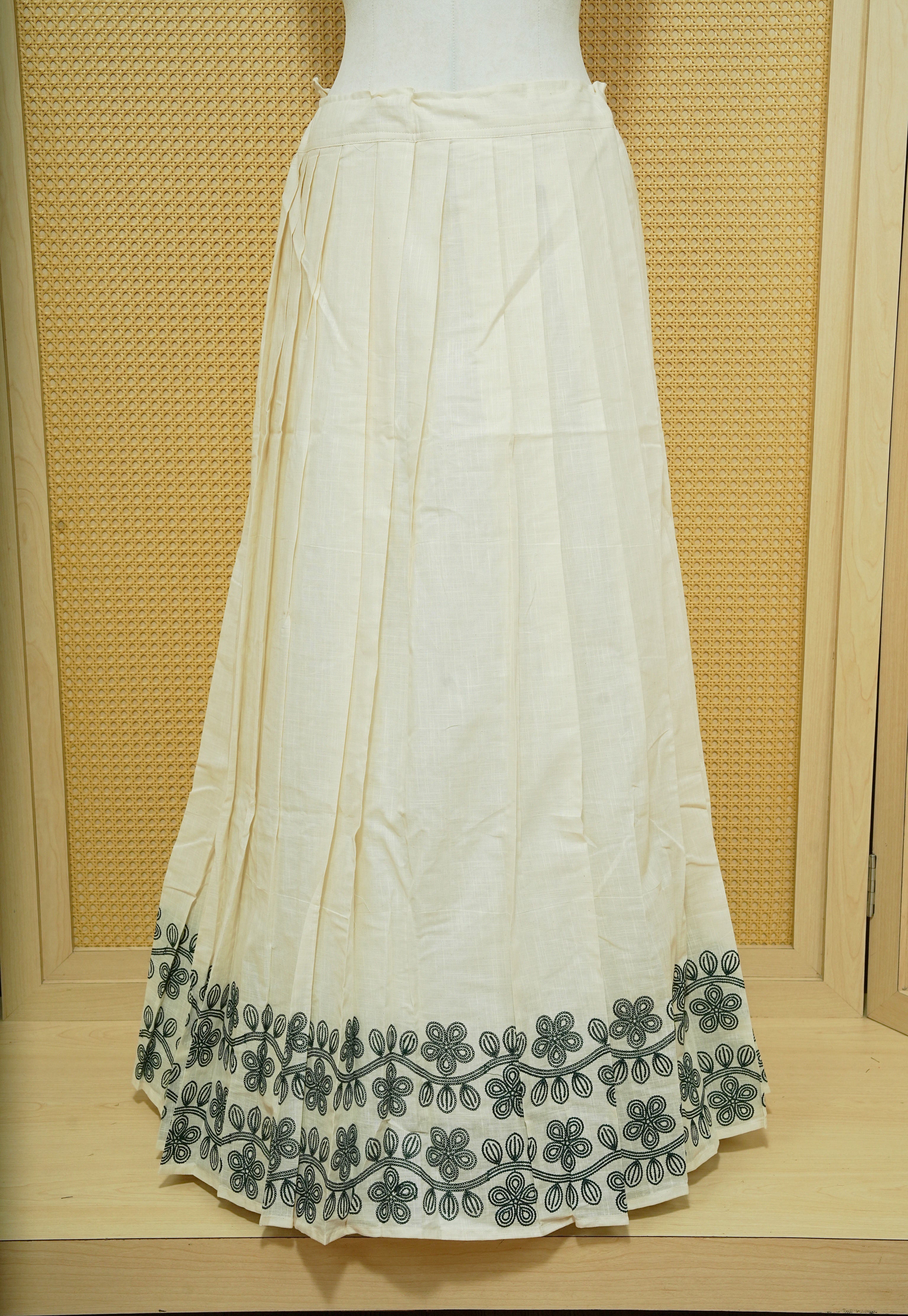 Cream colour cotton Stitched Skirt With Green colour Floral thread pattern on the border.