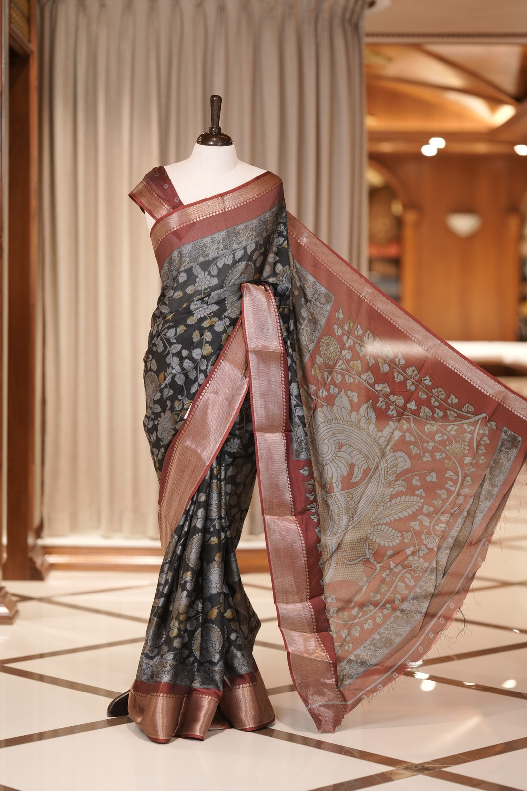 Ash & Maroon colour Kalamkari saree in Milan moss fabric featuring intricate Kalamkari print, Adorned with a rich copper zari border and stunning contrast color design on the pallu and blouse piece for a graceful look.