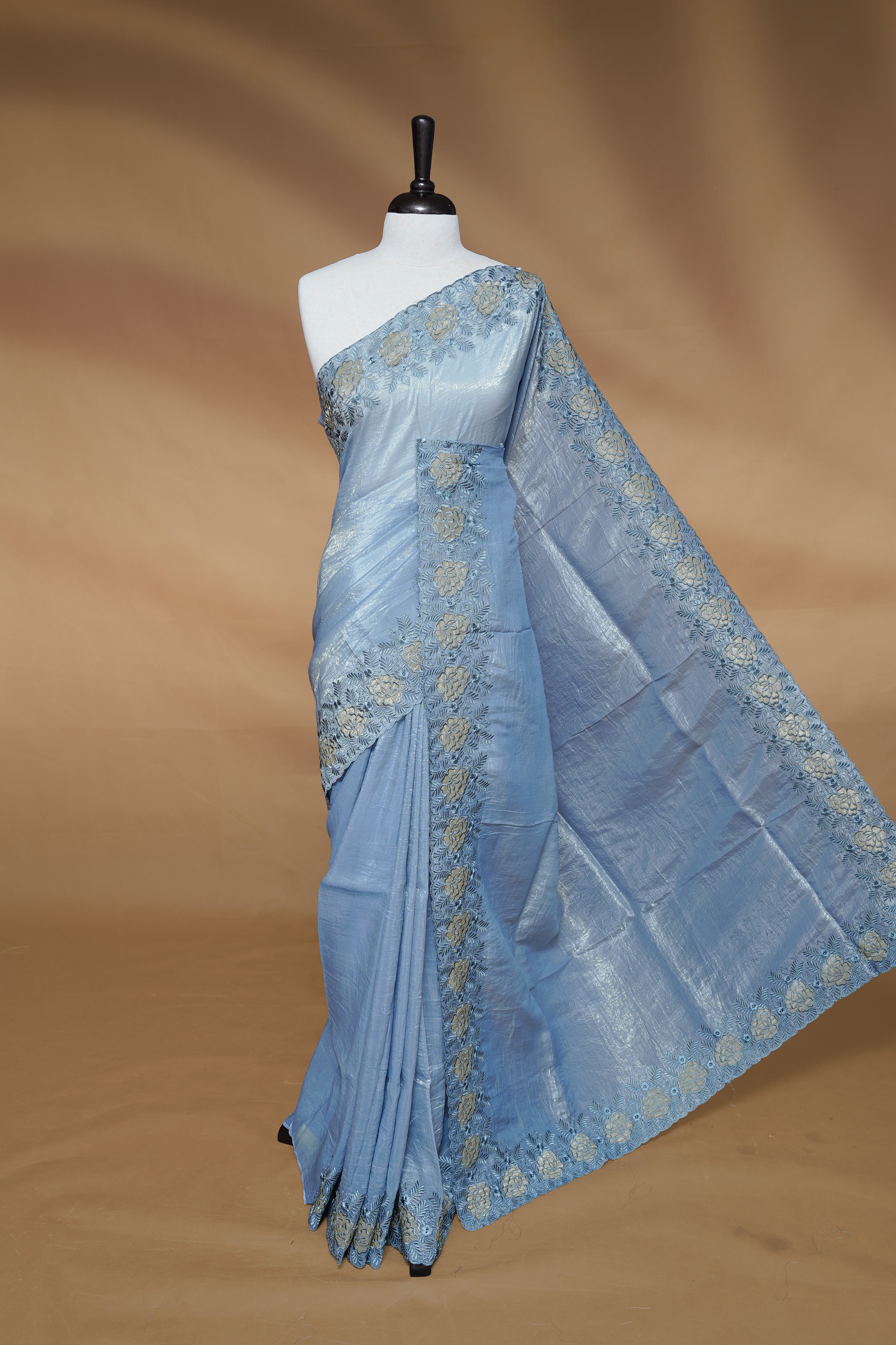 Pastel Blue colour Crush Organza Featuring Plain body, Enrich with Floral thread pattern & scalp border, paired with matching blouse piece.