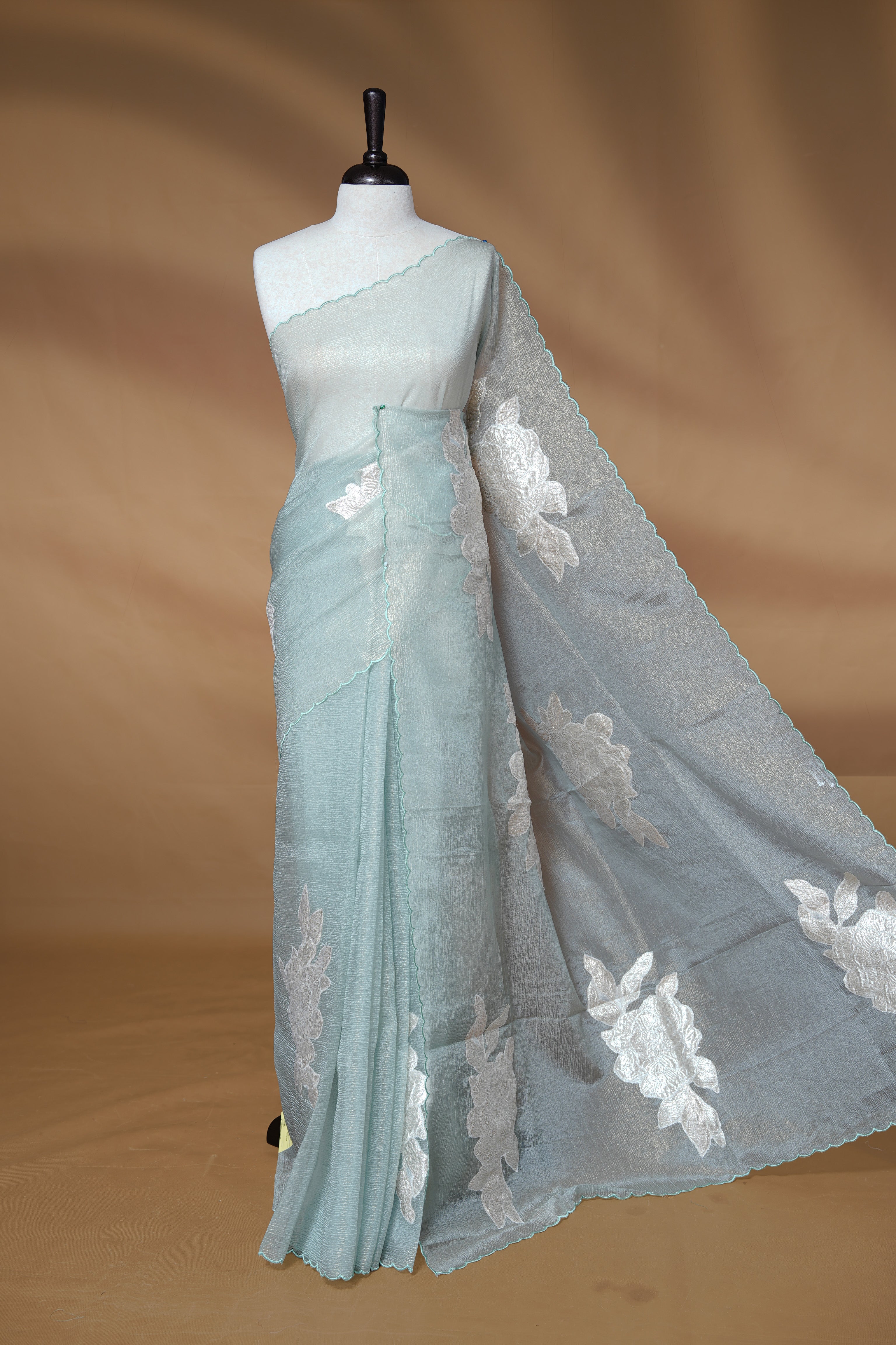 Pastel Green colour Crush Organza Saree featuring White floral Pattern on body, complemented by classy Thread border, paired with matching blouse piece.